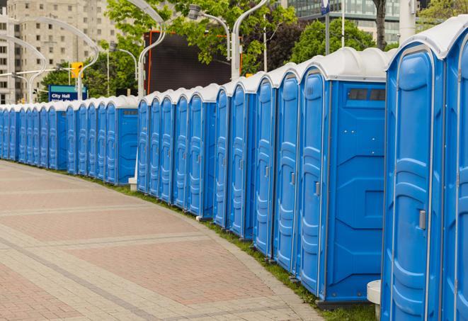 a fleet of portable restrooms ready for use at a large outdoor wedding or celebration in Carrolltown